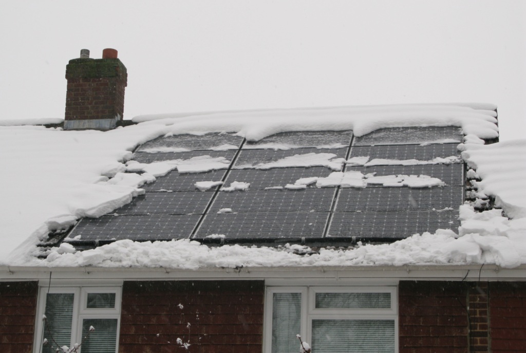 Roof with solar panels and some snow