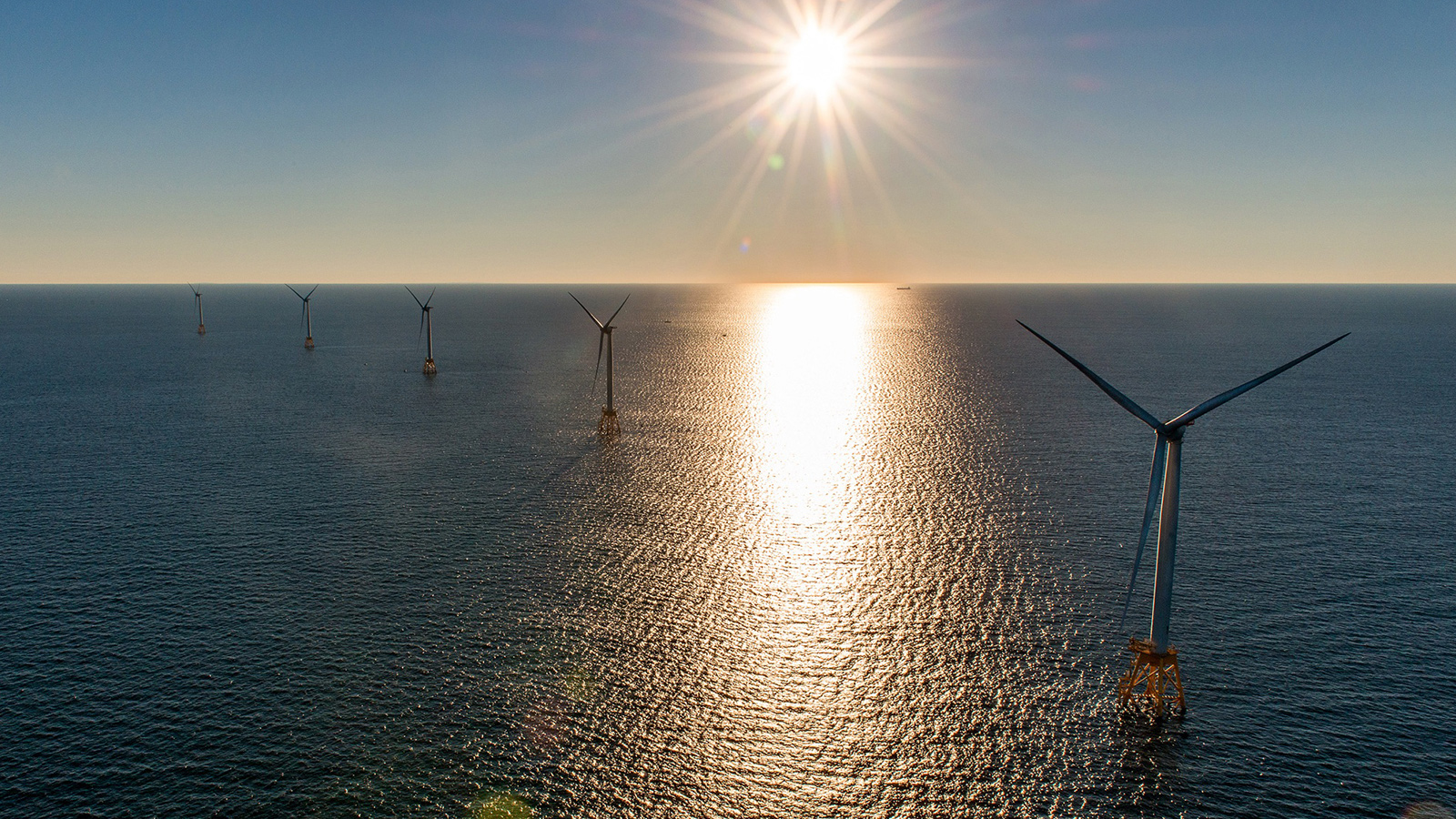 Sun setting over an offshore wind farm. Image courtesy of Deepwater Wind. 